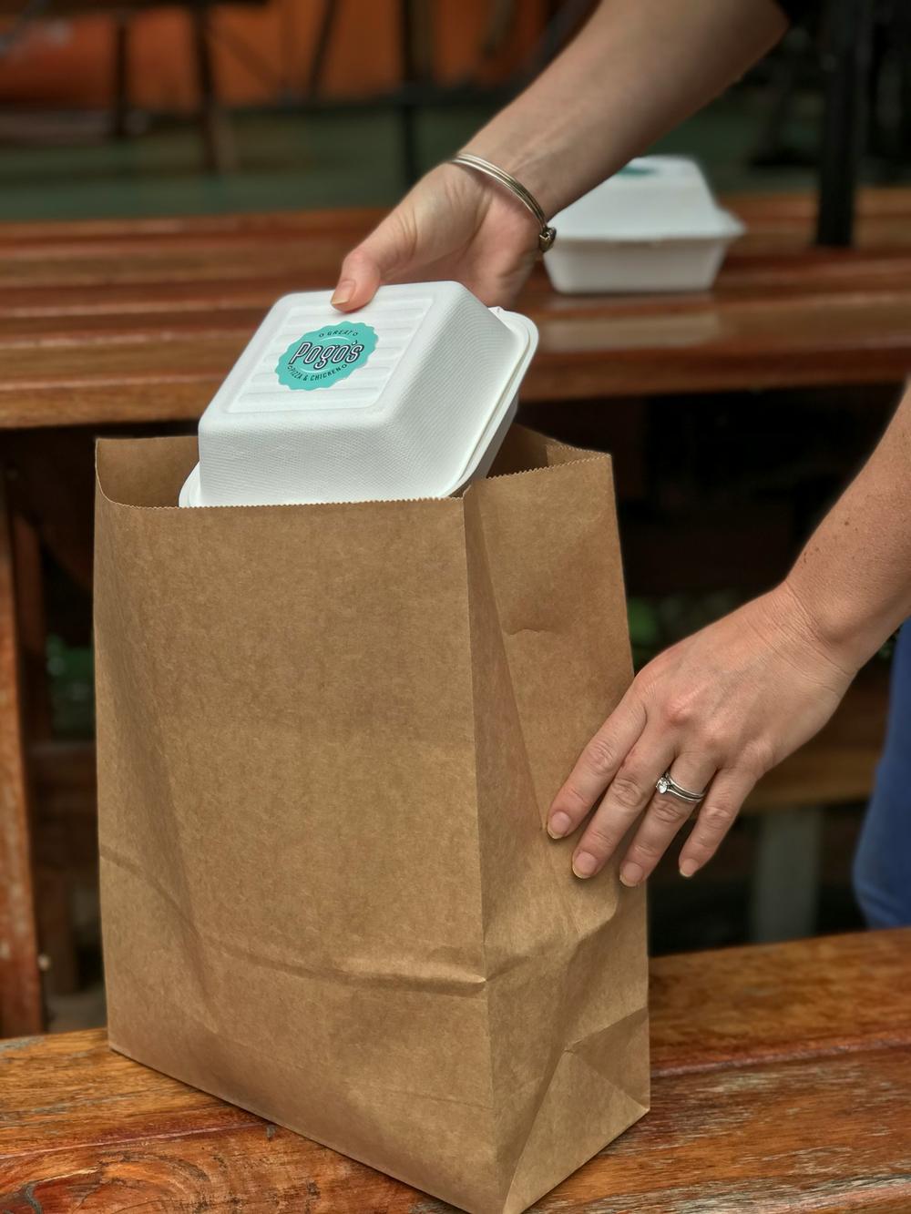 Packing a takeout order into a paper bag